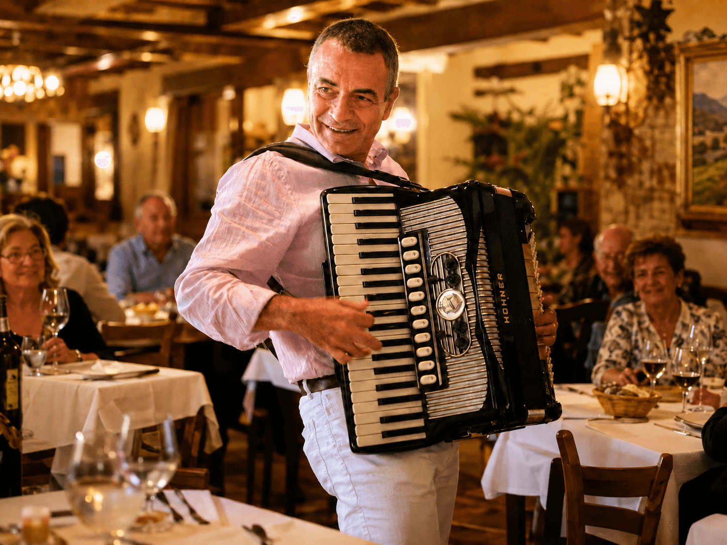 Frank Baggetta playing accordion among guests at a live event